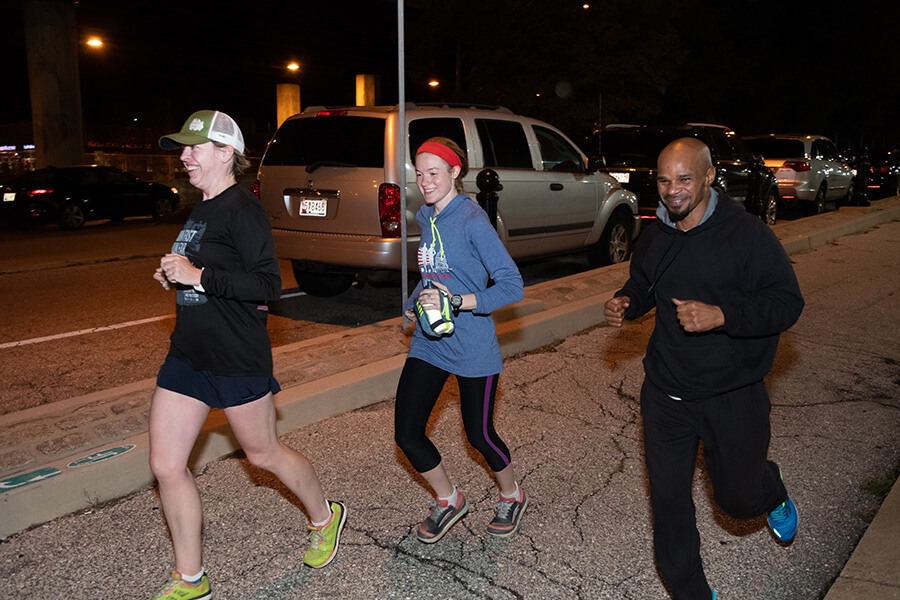 Back On Our Feet runners MaryBeth Nebel, from left, Suzie Brashler and Michael Martin take a pre-dawn run Oct. 15 on Fallsway near Our Daily Bread. (Kevin J. Parks/CR Staff)