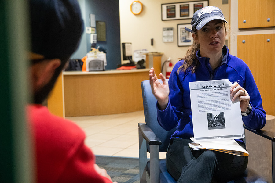 Marybeth Moran, program director of Back On Our Feet, explains the strict participation policy to new members of their running group Oct. 15 inside Our Daily Bread on Fallsway in Baltimore. (Kevin J. Parks/CR Staff)