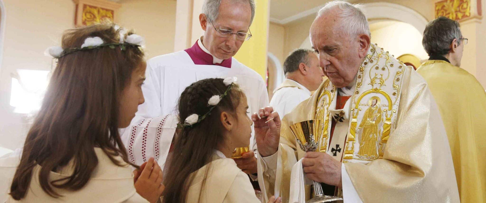 After offering instruction, pope gives first Communion to 245 children
