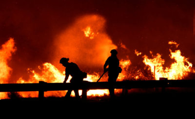 Firefighters battle a wind-driven wildfire Oct. 25, 2019, in Canyon Country near Los Angeles.