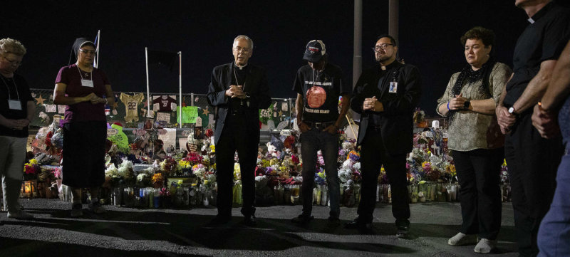 Bishop Mark J. Seitz and Father Fabian Marquez, both of El Paso, Texas, lead prayers Sept. 26, 2019, for Antonio Basco, who lost his wife, Margie Reckard, during the Aug. 3 Walmart mass shooting in El Paso.