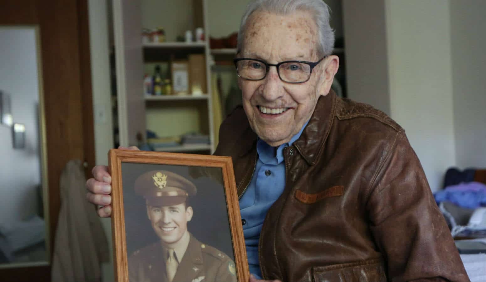 Don Stoulil of Sacred Heart Parish in Robbinsdale, Minn., holds a picture of himself Oct. 30, 2019, which was taken near the end of his tour of duty in World War II as a B-17 bomber pilot.
