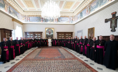 Pope Francis poses in the papal library Dec. 3, 2019