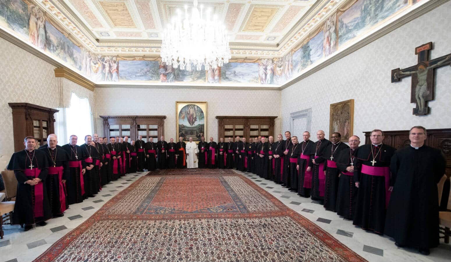 Pope Francis poses in the papal library Dec. 3, 2019