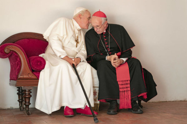 Anthony Hopkins portrays retired Pope Benedict XVI and Jonathan Pryce portrays Pope Francis in a scene from the movie "The Two Popes."