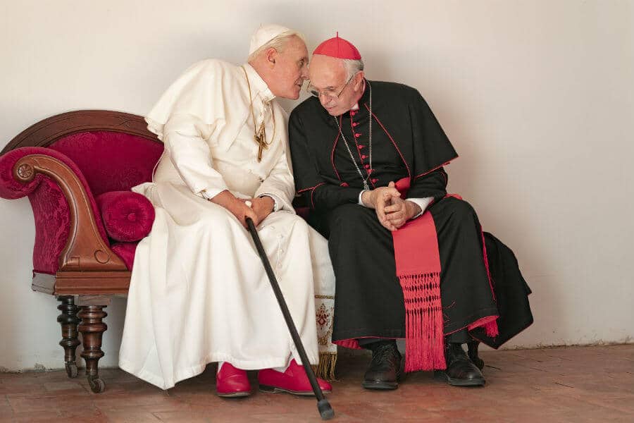 Anthony Hopkins portrays retired Pope Benedict XVI and Jonathan Pryce portrays Pope Francis in a scene from the movie "The Two Popes."